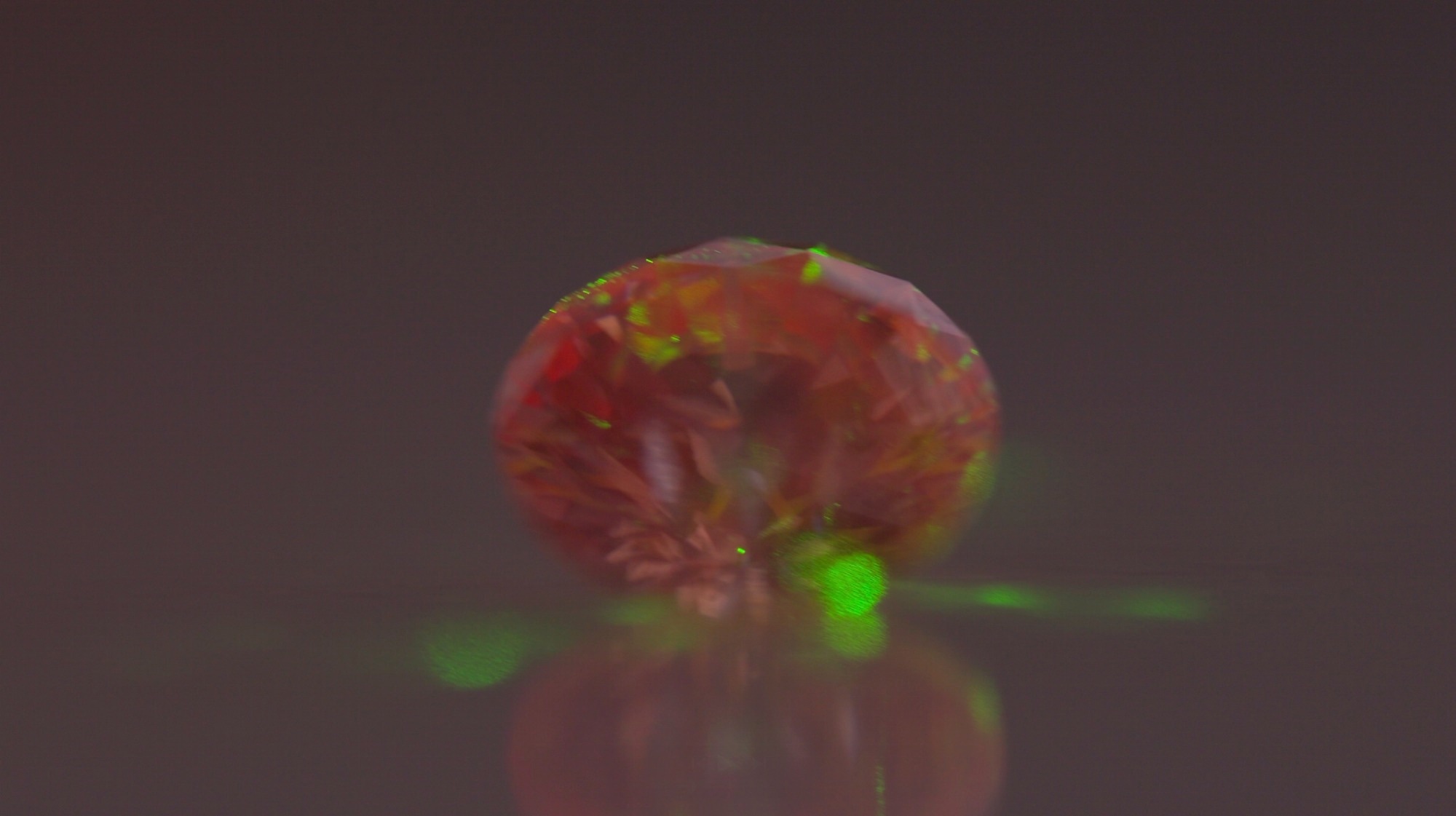 A nitrogen-vacancy center diamond glows red when excited by microwave pulses and SBQuantum