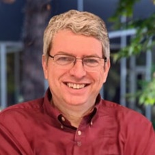 Solving Real-World Problems With Neutral Atoms: The Road to Fault-Tolerance
