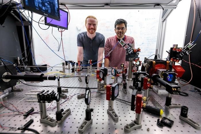 Combining Atom Arrays and Photonic Devices for Scalable Quantum Systems