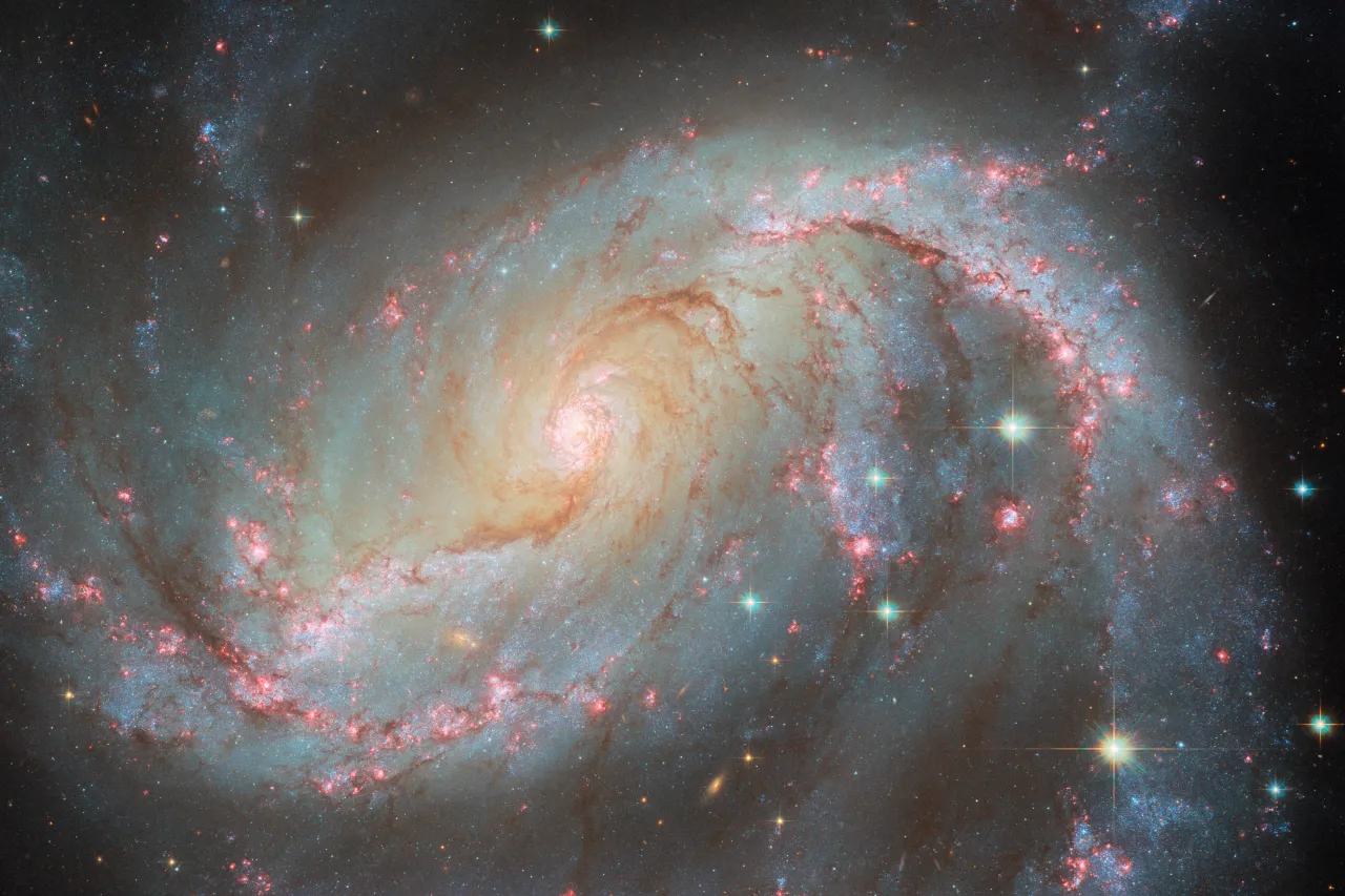 This NASA/ESA Hubble Space Telescope image captures the spiral galaxy NGC 1672 with a supernova