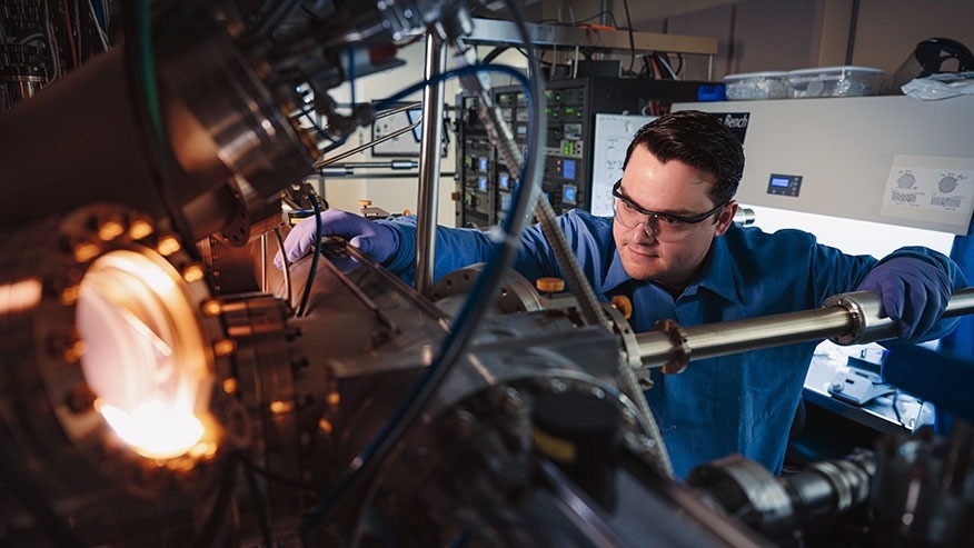 a researcher in the Microsoft Quantum Lab West Lafayette and a Purdue University doctoral student, uses a molecular beam epitaxy system to create hybrid superconductor-semiconductor structures