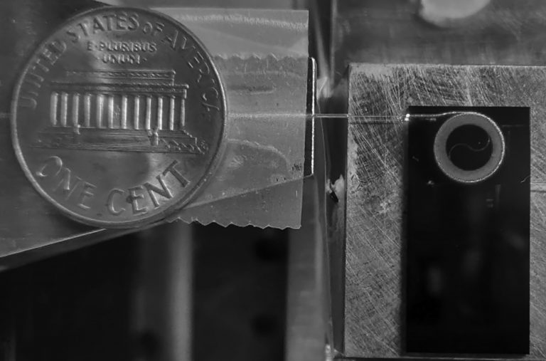 A photonic integrated circuit in which an ultralow loss 2-meter optical waveguide guiding visible light in the red spectrum is put on a silicon nitride chip smaller than a penny, important for applications such as strontium atomic clocks