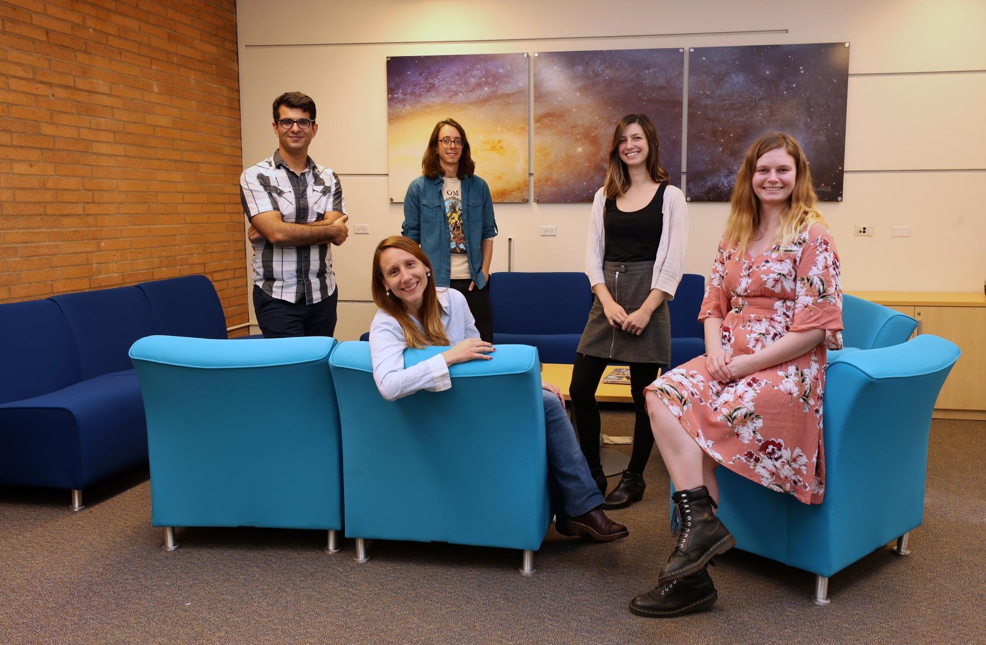 Laura Sales (seated, left) with her research group of former and current students, including Jessica Doppel (seated, right).