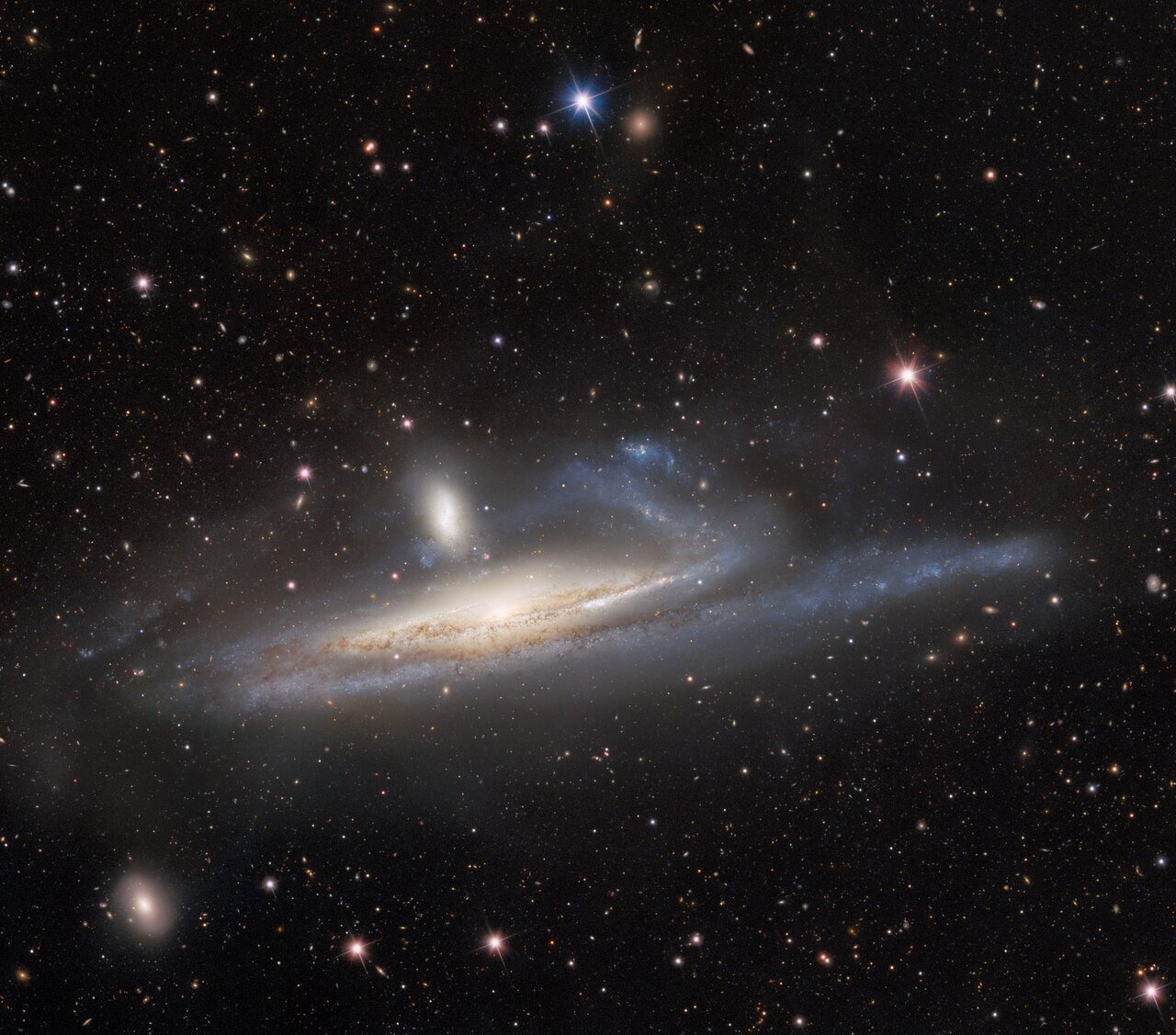 Capturing the Mutual Gravitational Influences of a Massive- and Dwarf-Galaxy Merger