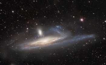 Capturing the Mutual Gravitational Influences of a Massive- and Dwarf-Galaxy Merger